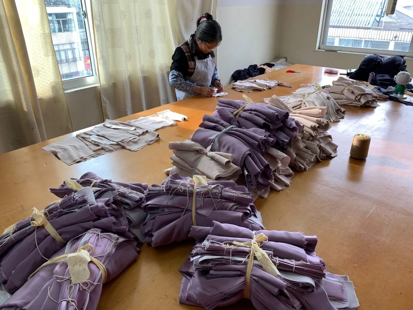 Cutting table with fabric lays being prepared