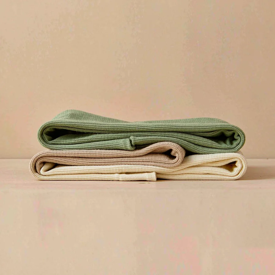 Folded cotton jersey knit fabrics in cream and sage